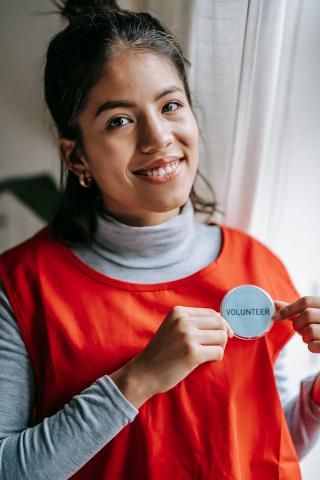 Image of woman with a volunteer badge